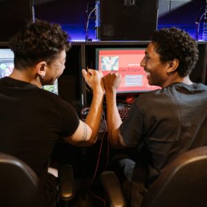 two teenage boys playing games at arcade