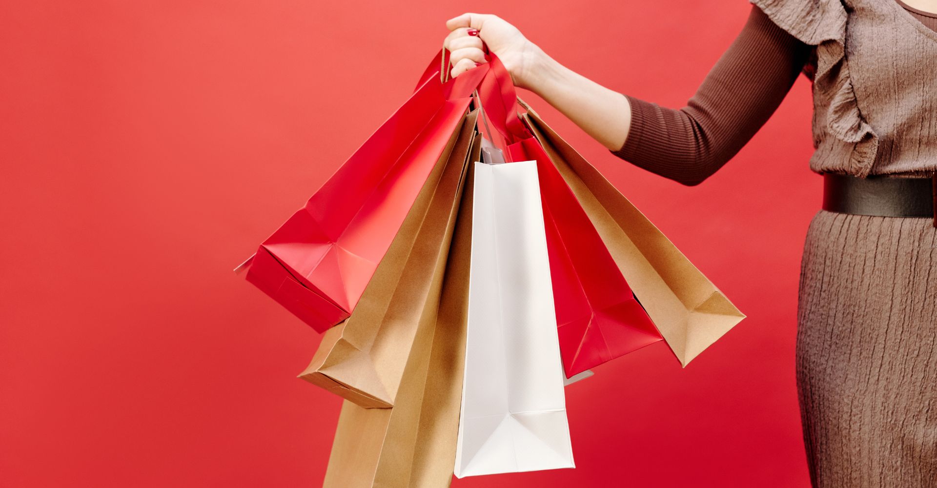 a person holding a variety of shopping bags
